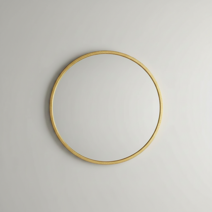 Gold wood-framed wall mirror studio shot on white background