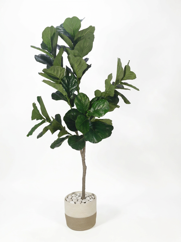 Artificial decorative plant with pot on white studio background