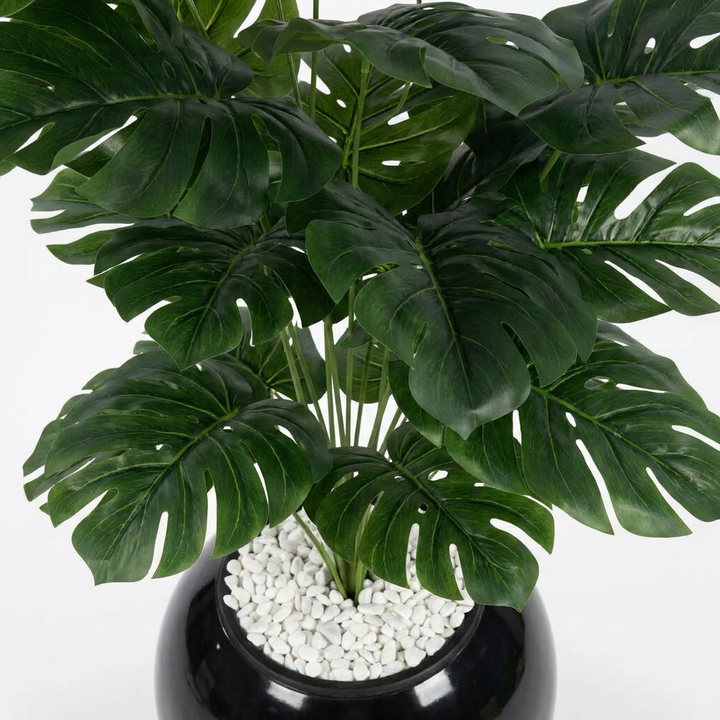 Close-up macro shot of artificial plant leaves on white background