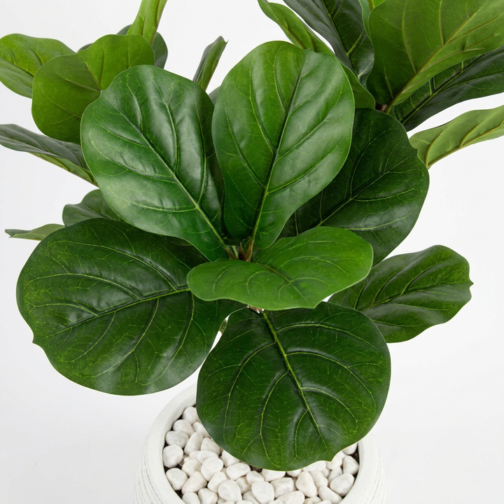 Close-up macro shot of artificial plant leaves with white pebbles
