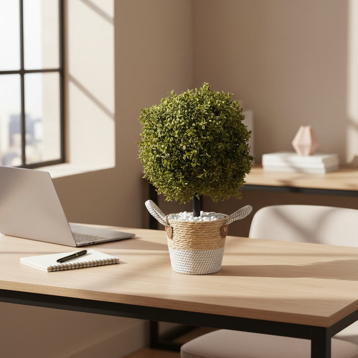 Artificial fern on modern office desk with laptop