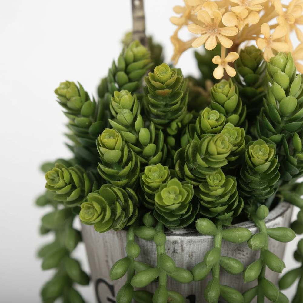 Close-up of artificial ivy delicate trailing leaves on white studio background