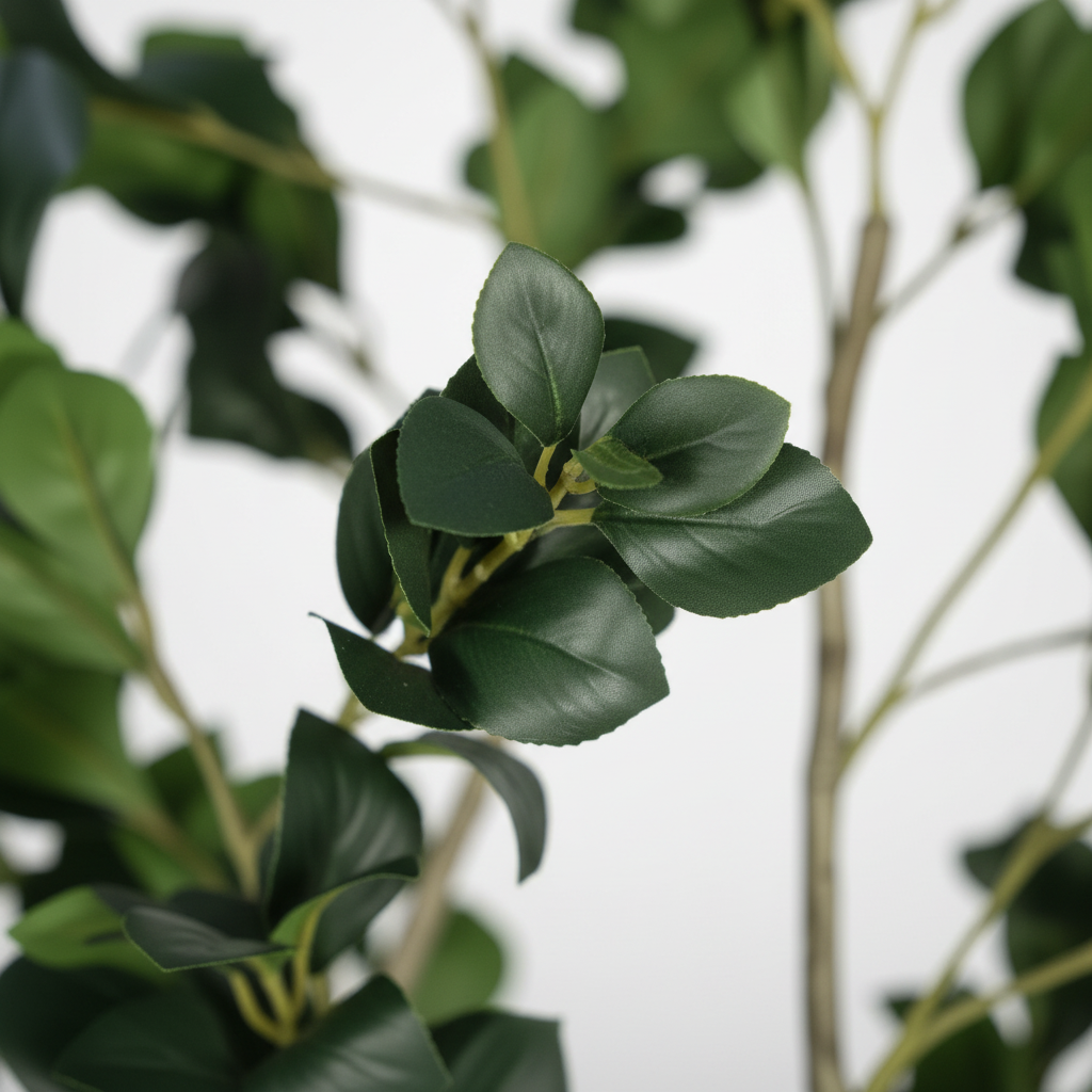 Close-up of artificial dracaena arching green and burgundy leaves on white studio background