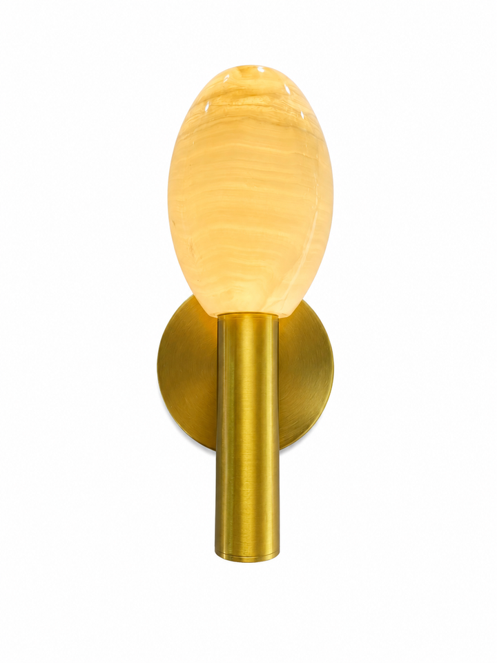Luxury oval alabaster wall sconce with a brushed antique brass mount, providing warm ambient lighting and elegant modern style.