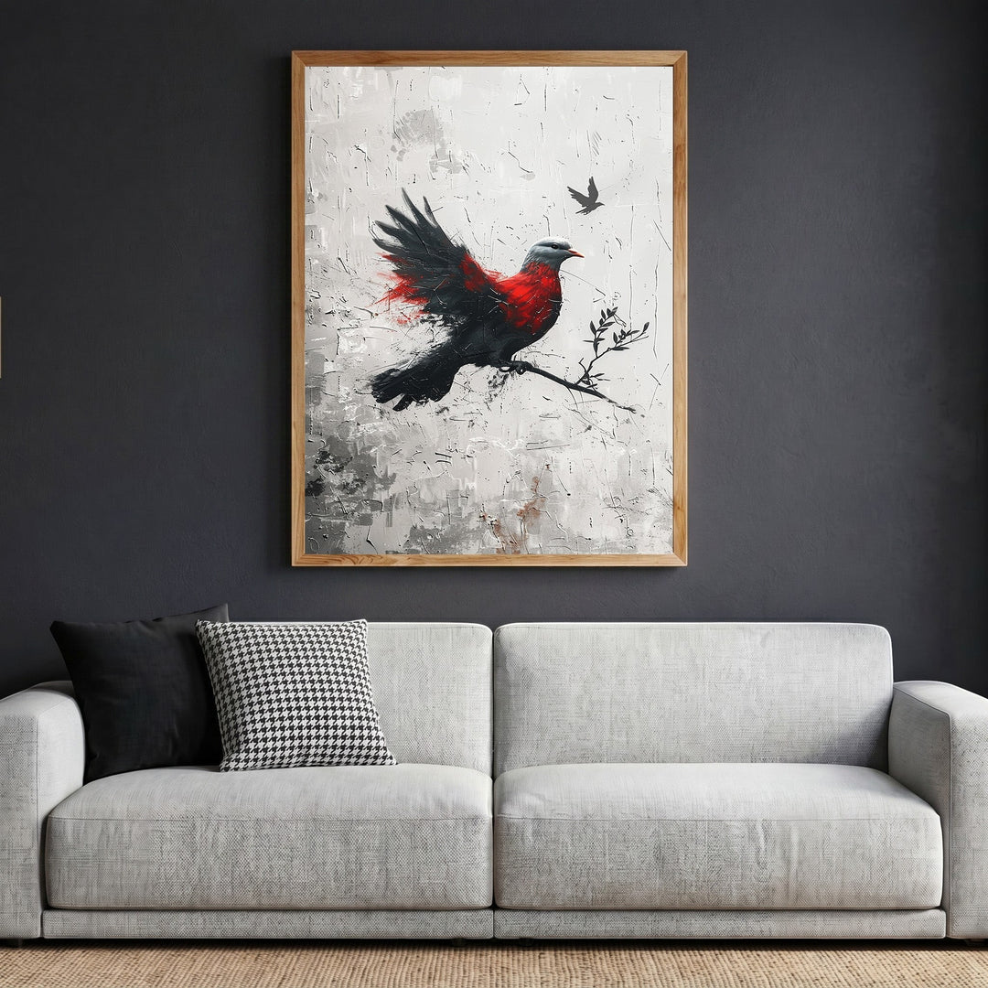 Wadi Home abstract bird canvas print with red and black brushstrokes in a wooden frame hanging above a modern sofa.