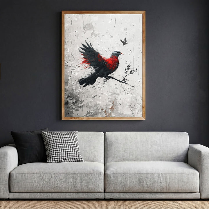 Wadi Home abstract bird canvas print with red and black brushstrokes in a wooden frame hanging above a modern sofa.
