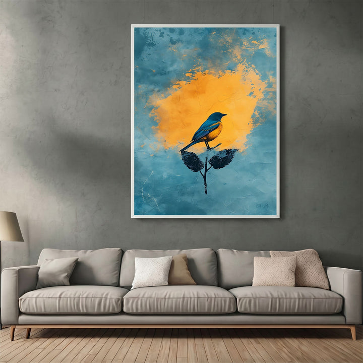 Wadi Home abstract bird wall art print with a blue and yellow design hanging above a modern grey sofa in a living room