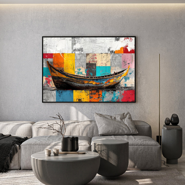 Wadi Home abstract boat wall art canvas with vibrant geometric background hanging above a modern grey sofa.