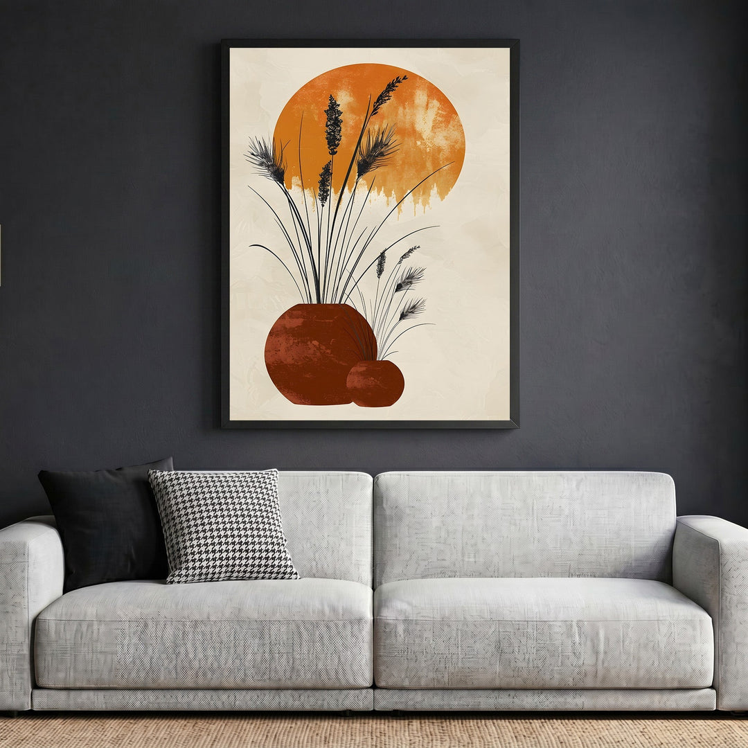 Wadi Home abstract botanical framed wall art with terracotta vessels and sun motif above a modern grey sofa.
