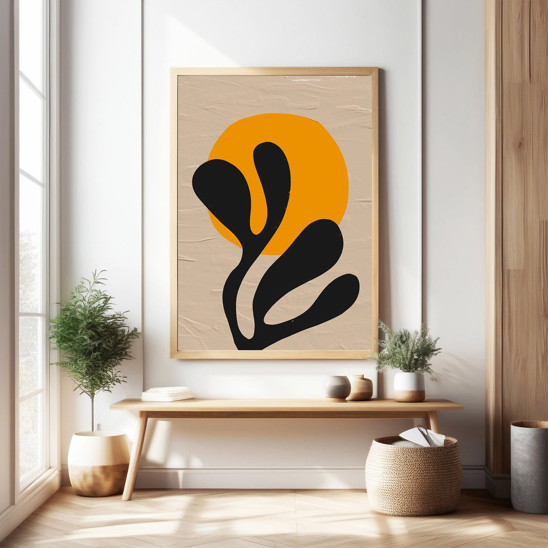 Wadi Home abstract botanical sunburst wall art with orange sun and black organic shapes on textured neutral background.