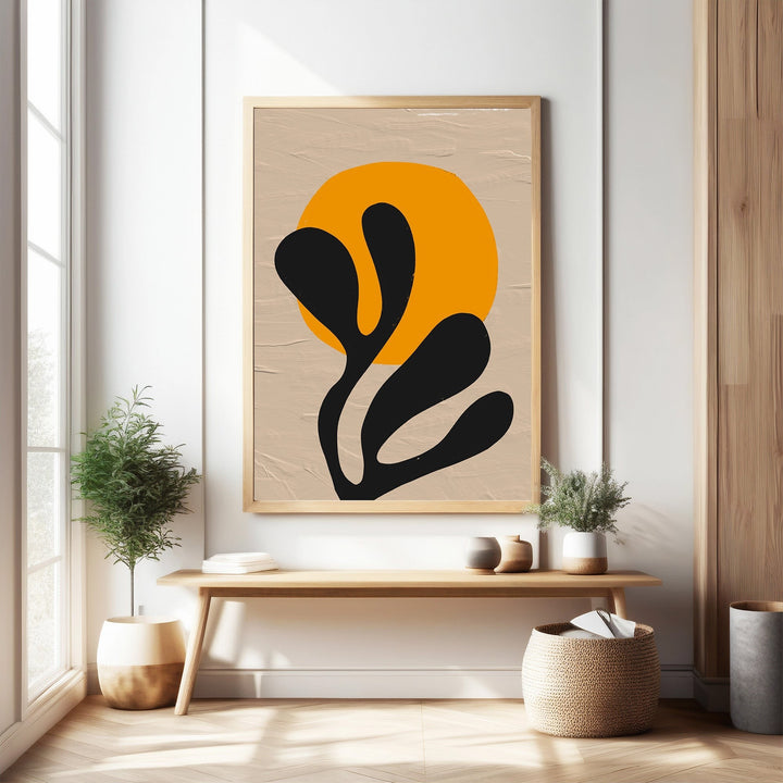 Wadi Home abstract botanical sunburst wall art with orange sun and black organic shapes on textured neutral background.