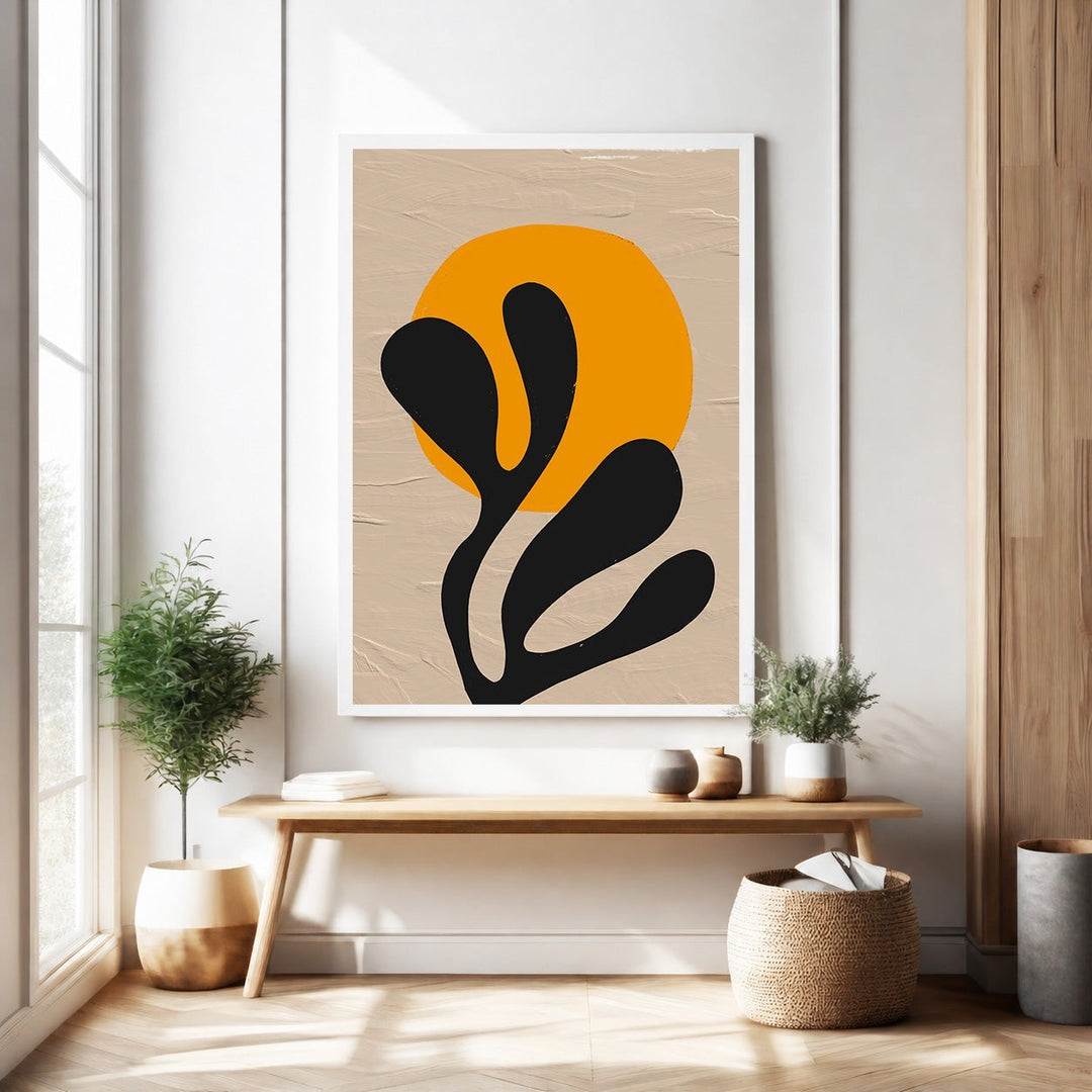 Wadi Home abstract botanical sunburst wall art with orange sun and black organic shapes on textured neutral background.