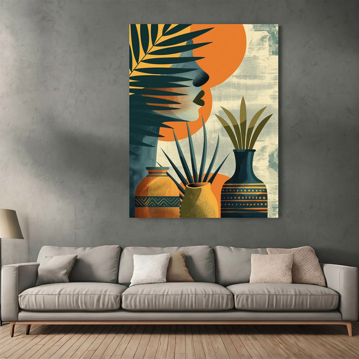 Wadi Home abstract botanical wall art print featuring tropical leaves, ceramic vessels, and orange sun on grey wall.