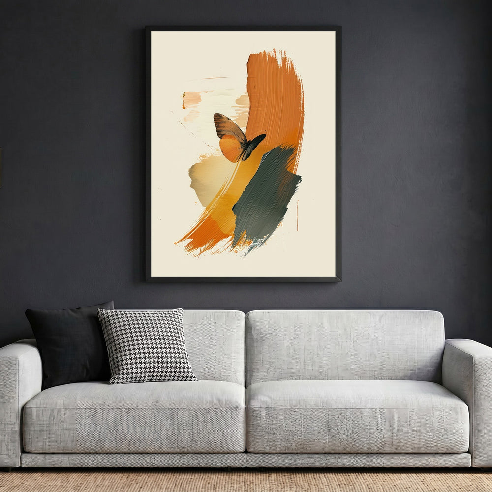 Wadi Home abstract butterfly wall art print with burnt orange and charcoal brushstrokes in a black frame above a sofa.