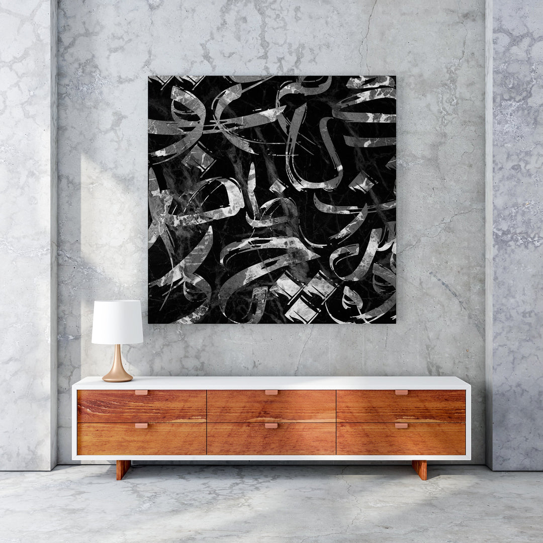 Wadi Home abstract calligraphy wall art with black and silver brushstrokes on a marble background.