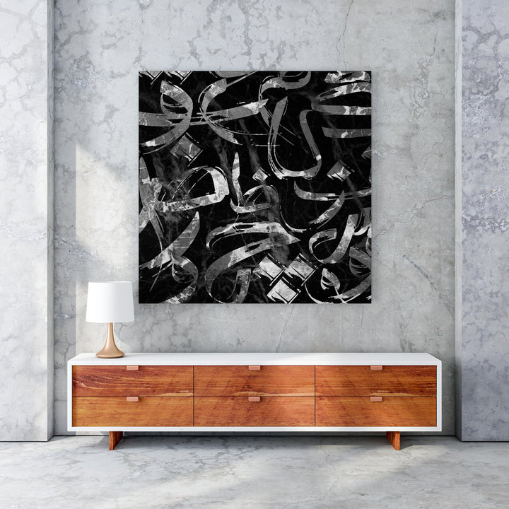 Wadi Home abstract calligraphy wall art with black and silver brushstrokes on a marble background.