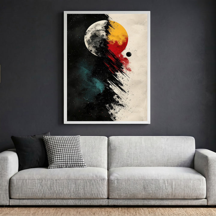 Wadi Home abstract celestial wall art print featuring a cosmic eclipse in black, red, and gold above a grey sofa.