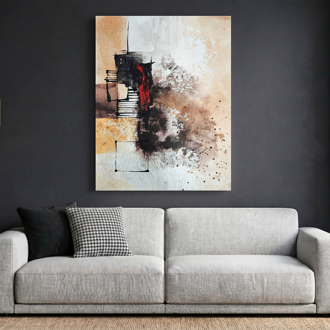 Wadi Home abstract expressionist canvas print with earth tones, black, and crimson accents hanging above a sofa.