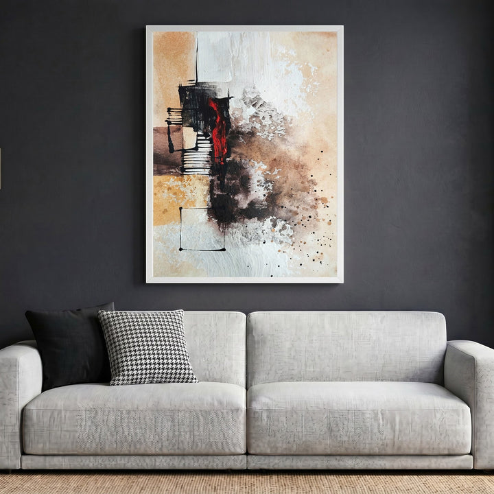 Wadi Home abstract expressionist canvas print with earth tones and crimson accents in a white frame above a sofa.