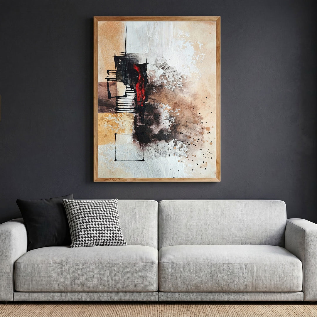 Wadi Home abstract expressionist canvas print with earth tones and crimson accents in a wooden frame above a sofa.
