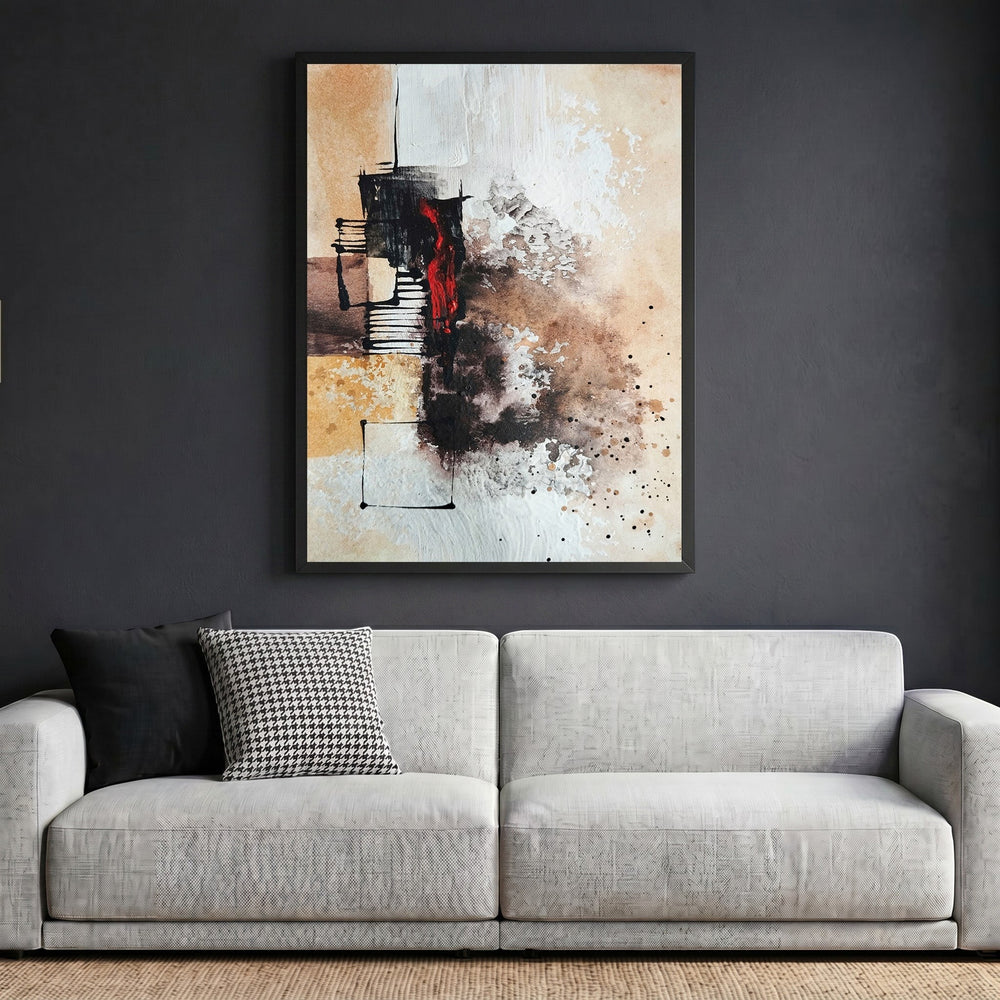 Wadi Home abstract expressionist canvas print with earth tones and crimson accents in a black frame above a sofa.