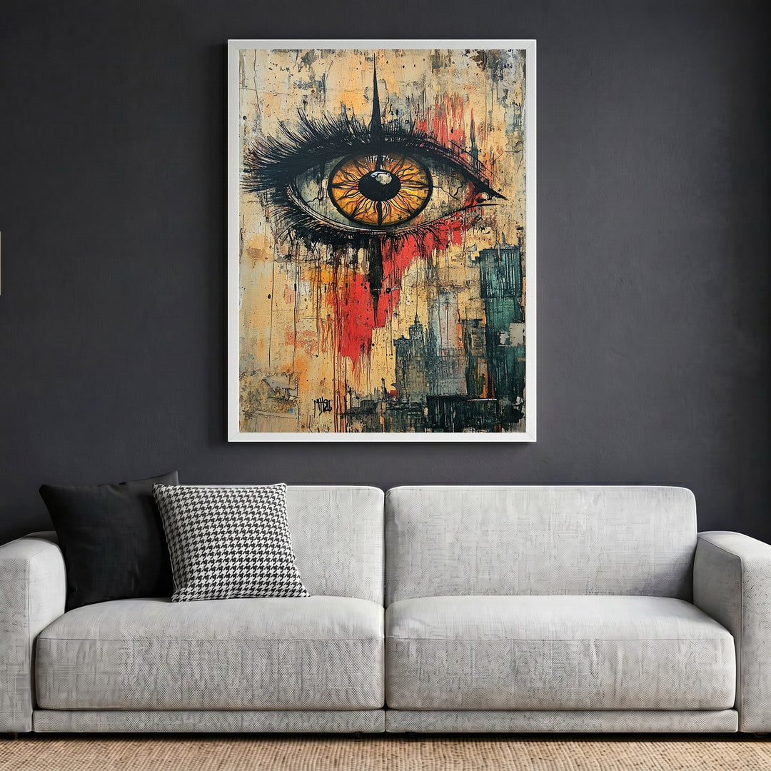Wadi Home abstract eye wall art in a white frame hanging above a modern grey sofa in a living room.