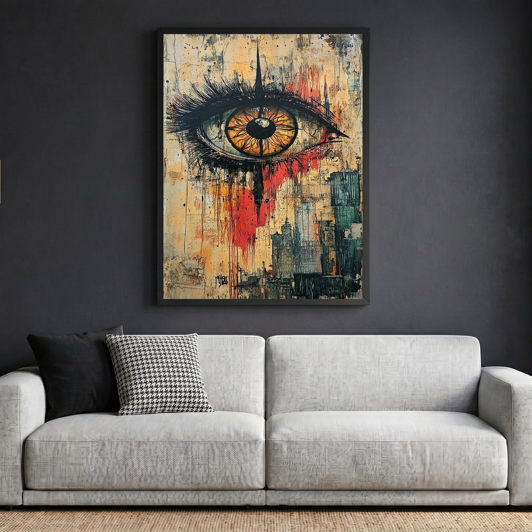 Wadi Home abstract eye wall art print in a black frame hanging above a modern grey sofa in a living room.