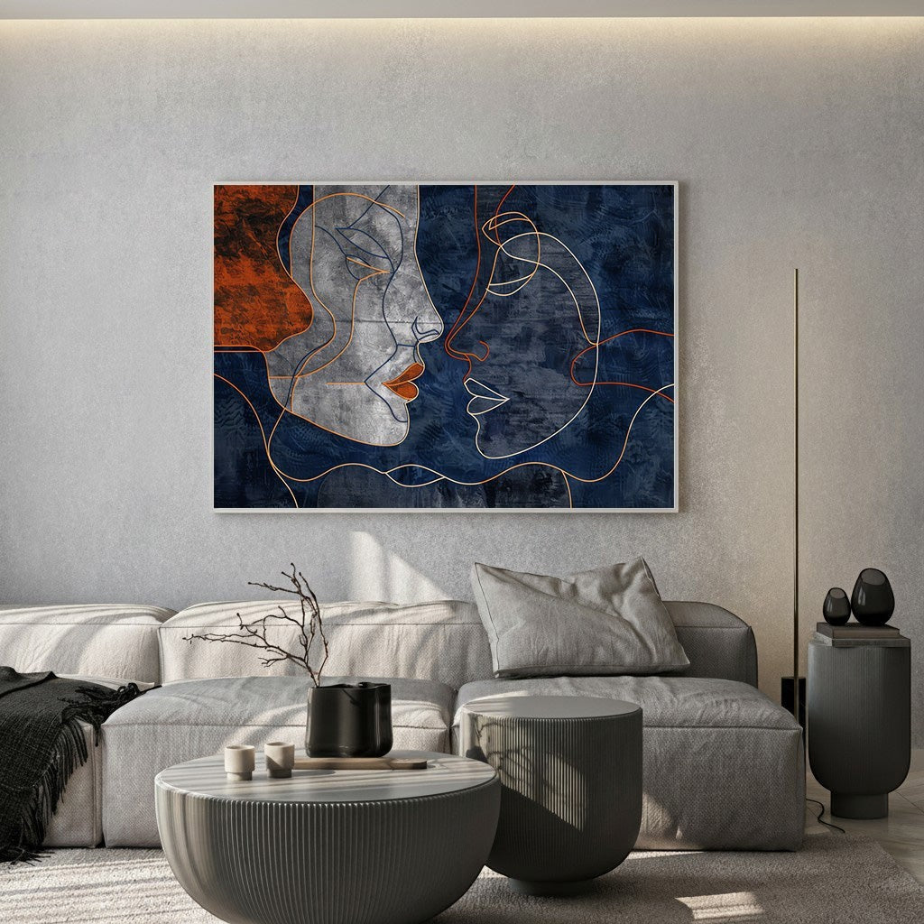 Wadi Home abstract faces line art canvas print with navy and terracotta tones displayed above a modern grey sofa.