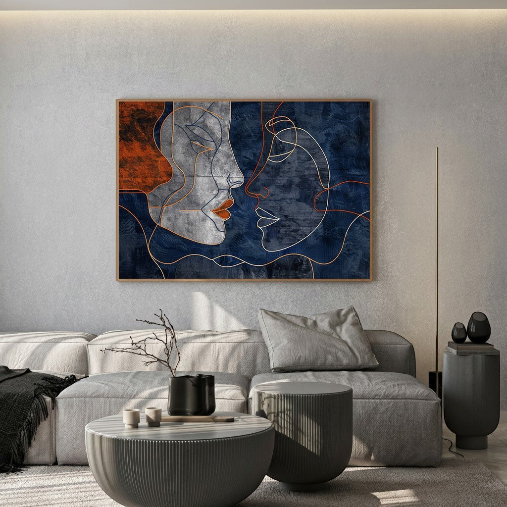 Wadi Home abstract faces line art canvas print in navy and terracotta displayed above a modern grey sofa.