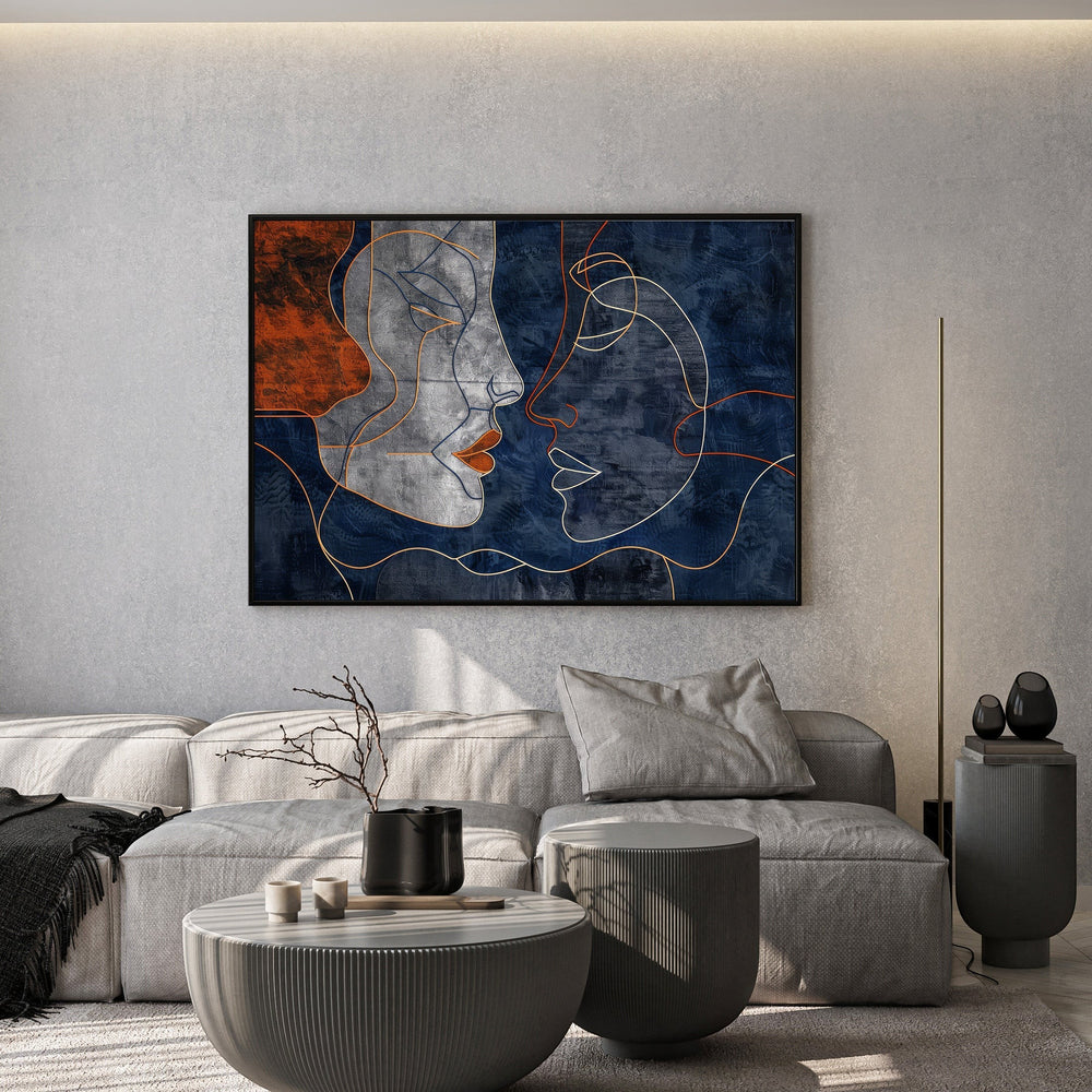 Wadi Home abstract faces line art canvas print with navy and terracotta tones hanging above a modern grey sofa.