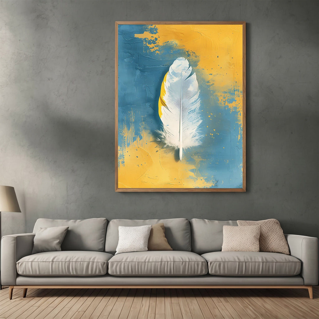 Wadi Home abstract feather canvas print with white feather on textured blue and yellow background above grey sofa.
