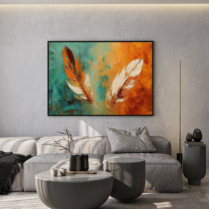 Wadi Home abstract feather canvas painting with teal and orange textured brushwork hanging above a modern grey sofa.