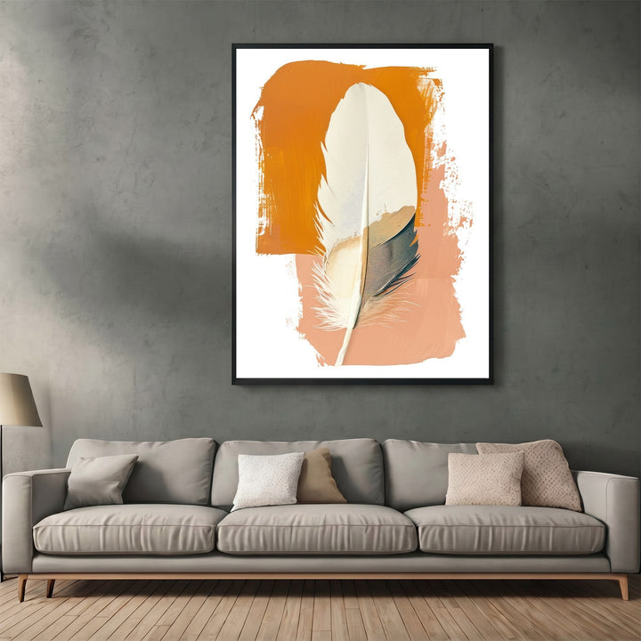 Wadi Home abstract feather wall art print with burnt orange and terracotta brushstrokes in a black frame above a sofa