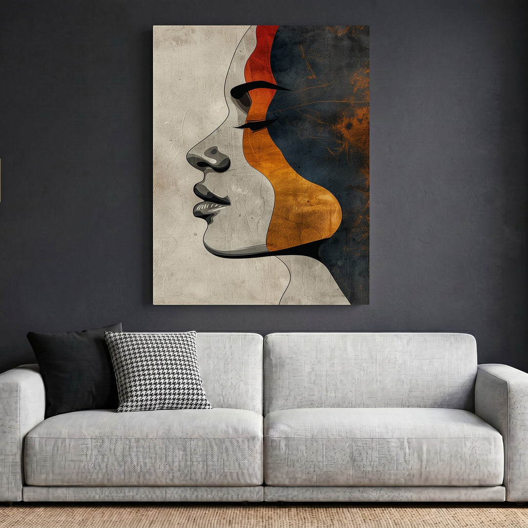 Wadi Home abstract female profile wall art print featuring terracotta, charcoal, and ochre tones above a modern sofa.