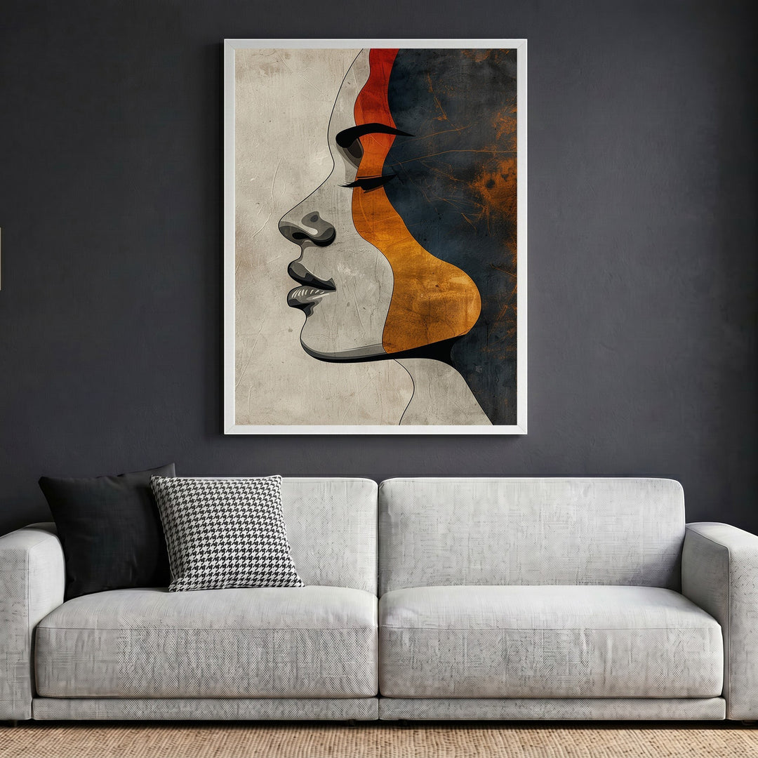 Wadi Home abstract female profile wall art print featuring terracotta, charcoal, and ochre tones in a white frame.