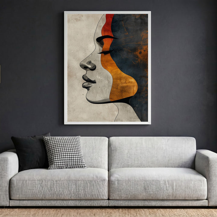Wadi Home abstract female profile wall art print featuring terracotta, charcoal, and ochre tones in a white frame.