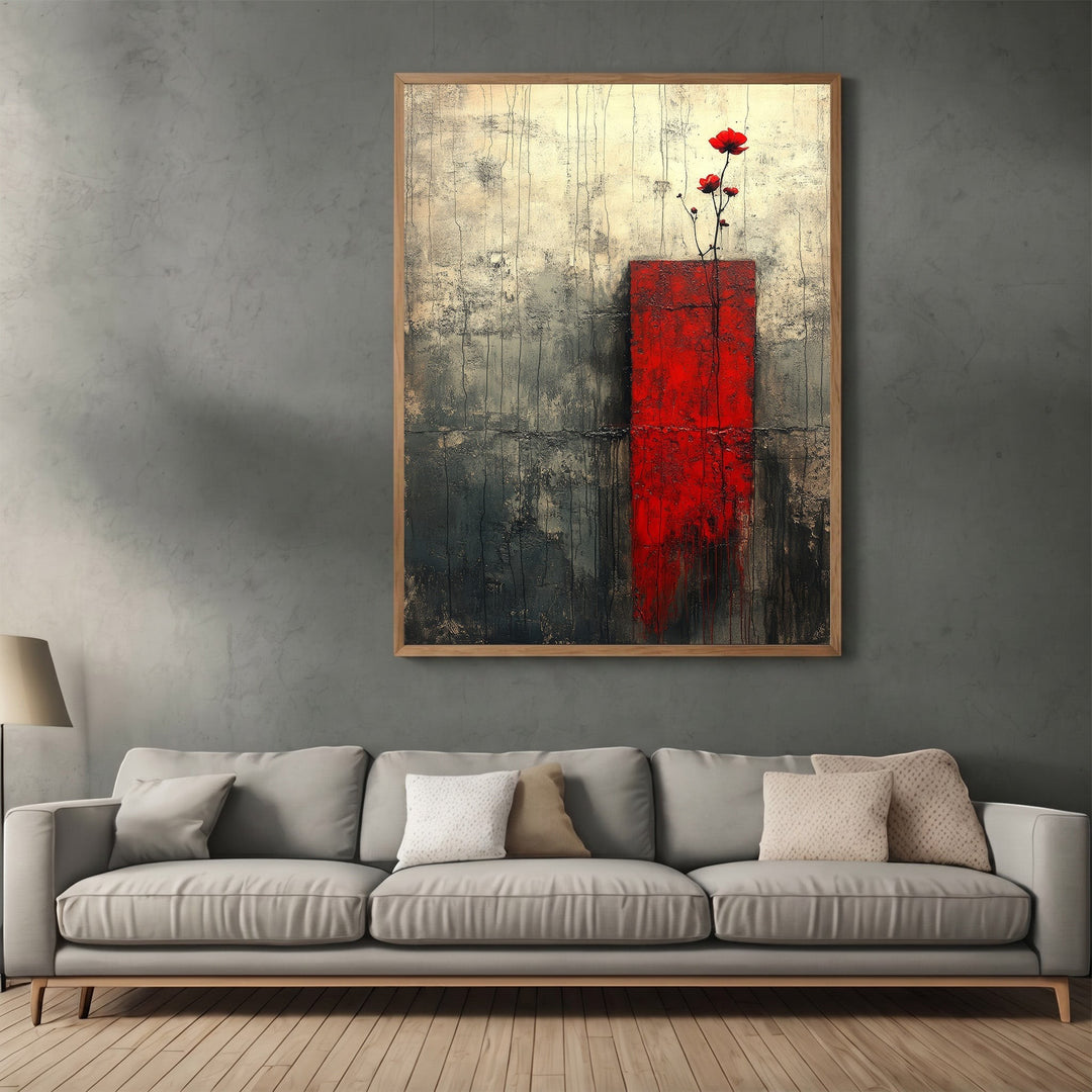 Wadi Home abstract floral canvas print with red block and charcoal textures hanging above a modern grey sofa.