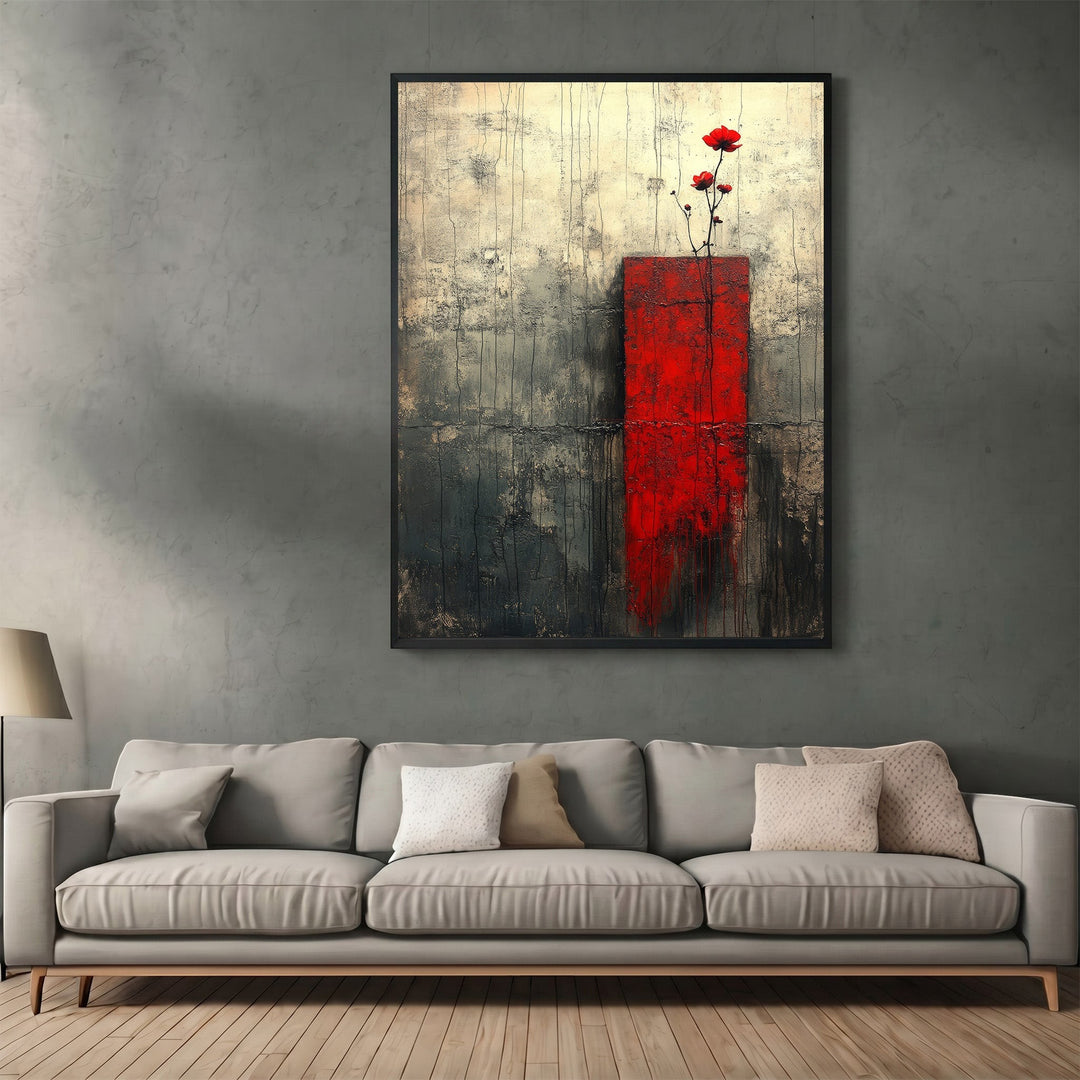 Wadi Home abstract floral canvas print with red block and charcoal textured background hanging above a grey sofa.