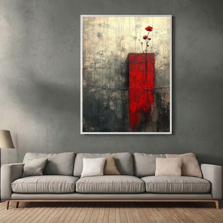 Wadi Home abstract floral canvas print with red accent and charcoal textured background hanging above a grey sofa.