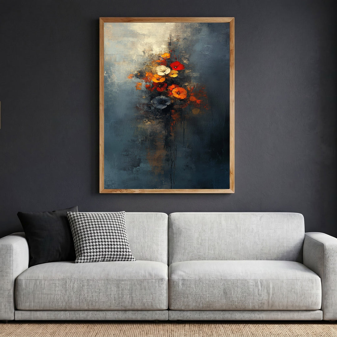 Wadi Home abstract floral bouquet wall art in a wooden frame hanging above a modern grey sofa against a dark wall.