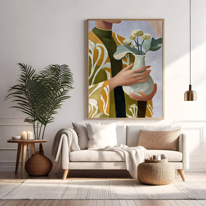 Wadi Home abstract floral vase wall art with figure in green and yellow patterned robe holding a vase of flowers.