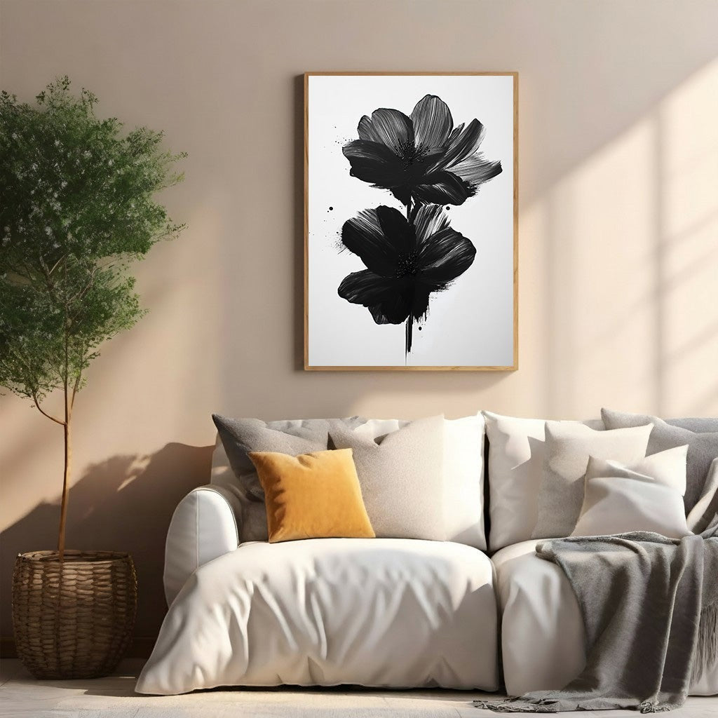 Wadi Home abstract black floral wall art with bold brushstrokes on white background, framed in light wood.