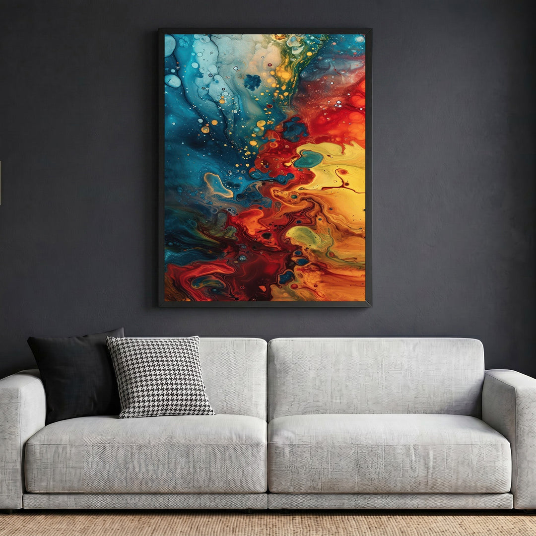 Wadi Home abstract fluid art canvas print with blue, red, and yellow swirls in a black frame above a modern sofa.