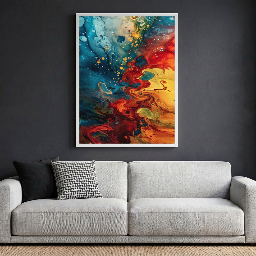 Wadi Home abstract fluid art canvas print with blue, red, and yellow swirls in a white frame above a modern sofa.