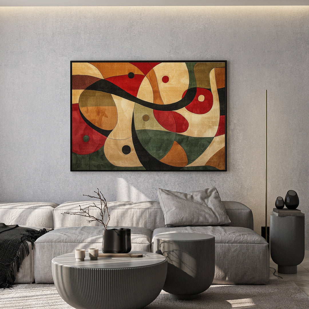 Wadi Home abstract geometric canvas print with red, green, and ochre shapes hanging above a modern grey sofa.