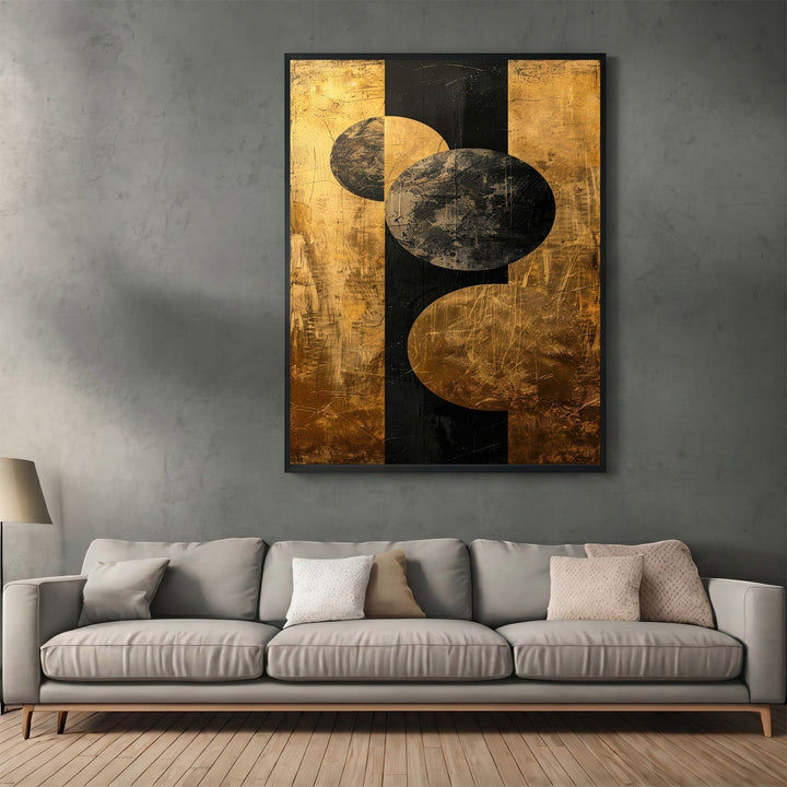 Wadi Home abstract geometric canvas print with black and metallic gold circles hanging above a modern grey sofa.