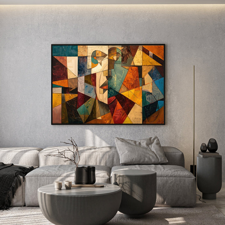 Wadi Home abstract geometric canvas print with ochre, teal, and orange tones hanging above a modern grey sofa.