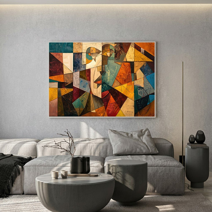 Wadi Home abstract geometric canvas print with ochre, teal, and orange tones hanging above a modern grey sofa.