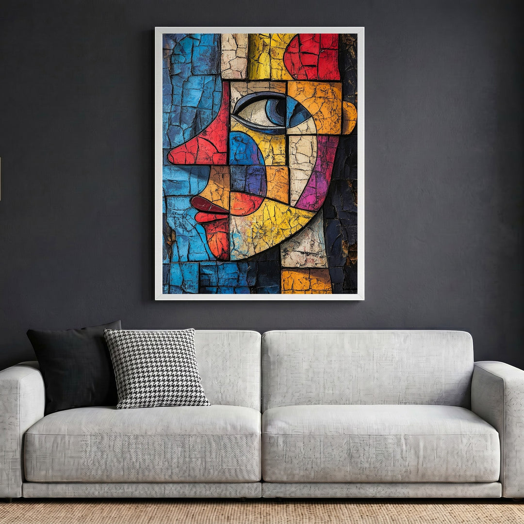 Wadi Home abstract geometric face wall art with cracked texture in a white frame above a modern grey sofa.