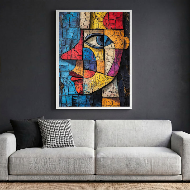 Wadi Home abstract geometric face wall art with cracked texture in a white frame above a modern grey sofa.